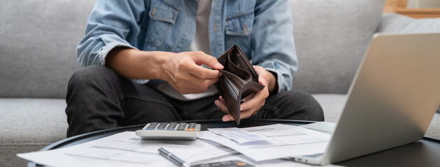 Bankruptcy problem financial concept, Young man opening empty wallet stress to find money to pay debt mortgage  period. - obrazy, fototapety, plakaty