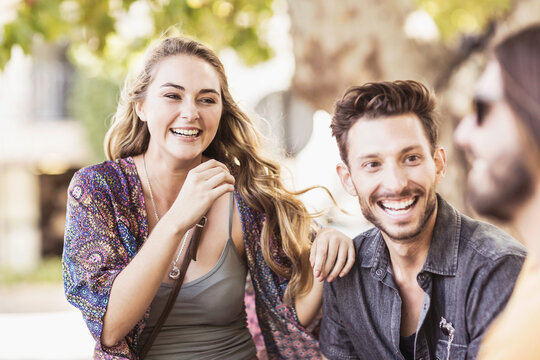 Friends having a happy time at an outdoor restaurant.