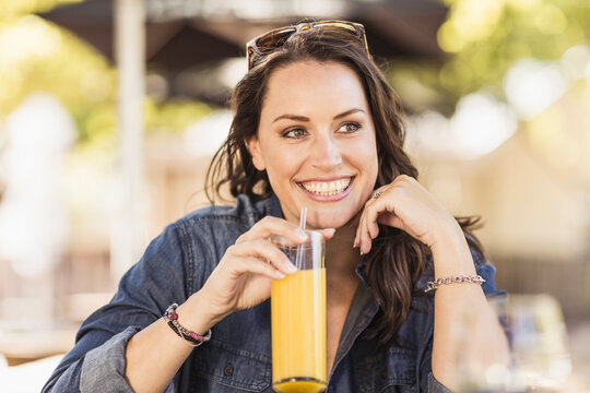 Beautiful happy woman having a great time at an outdoor restaurant.