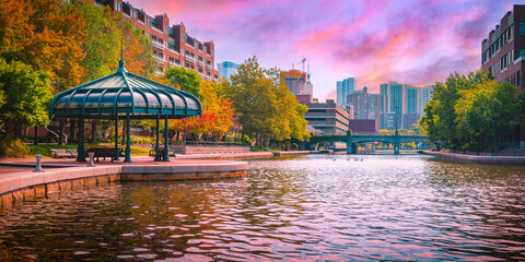 Boston City Vibrant Autumn Skyline with the Pavillion and Pond over Lechmere Canal Park in Massachusetts. Colorful New England Fall Landscape in America.