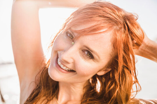 Portrait of young beautiful woman in a bikini on the beach