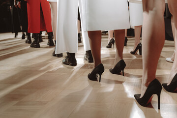 Black high heels. Fashion models walking the final Fashion show