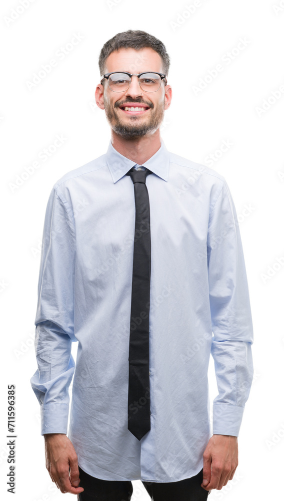 Sticker Young business man with a happy face standing and smiling with a confident smile showing teeth