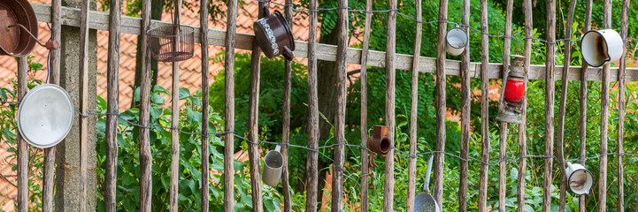 Countryside Detail of Traditional Wooden Fence decorated with old pots and lantern - 711598577