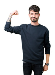 Young handsome man over isolated background Strong person showing arm muscle, confident and proud of power