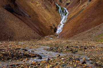 A waterfall in rainbow mountains in Landmannalaugar national park, Iceland.