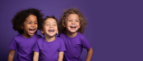 Portrait of three laughing Toddler children of different races on bright purple background....
