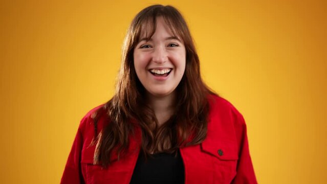 Portrait of caucasian woman 20s puts hand to ear to listen to secret isolated on yellow background studio with copy space