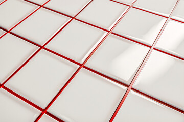 White ceramic tiles with red grout from an angle