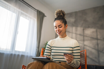 young woman caucasian female hold credit card online shopping at home