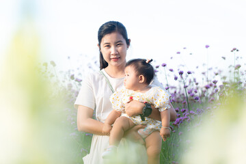 Mother and child in the flower field,Beautiful mother and daughter in spring poppy flower field....