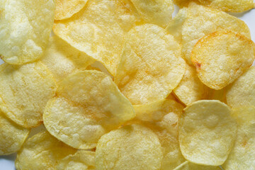 Macro Potato Snacks,Crispy potato chips texture background top view,abstract background of potato chips food texture 