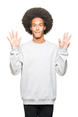 Young african american man with afro hair wearing sporty sweatshirt showing and pointing up with fingers number nine while smiling confident and happy.