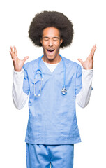 Young african american doctor man with afro hair celebrating mad and crazy for success with arms...