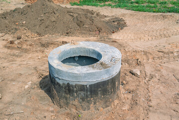 Sewer well during excavation work. Installation of sewer networks. Laying of sewers underground. A...
