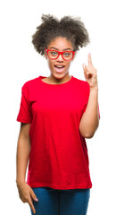 Fototapeta na wymiar Young afro american woman wearing glasses over isolated background pointing finger up with successful idea. Exited and happy. Number one.