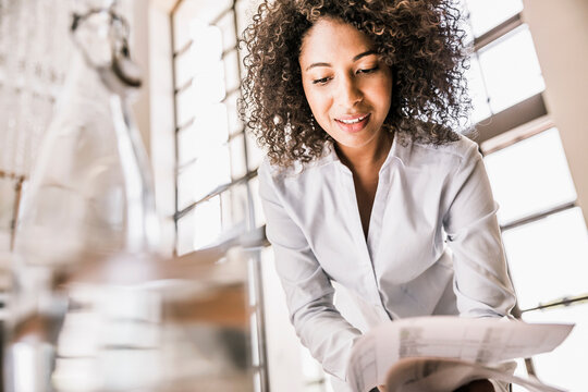 Portrait of businesswoman going through some paper work in the office