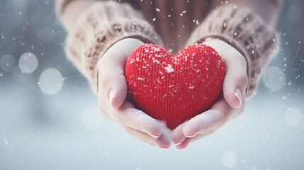 Fototapeta premium Hands Holding Red Heart in Snowy Weather,valentine