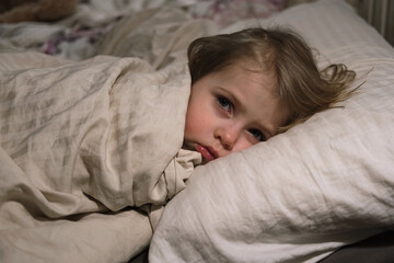 Obraz premium Child Falls Asleep. Peaceful Adorable Baby Sleeping at Home. Slumbering Little Toddler. Two Years Old Girl Sleeps. Nursery Room Interior Background. Serene Dream. Cute Face Close Up. Deep Kid Slumber