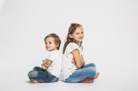 Portrait of two children in studio with white background.