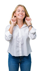 Beautiful young business woman over isolated background Smiling pulling ears with fingers, funny gesture. Audition problem