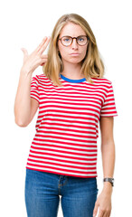 Beautiful young woman wearing glasses over isolated background Shooting and killing oneself pointing hand and fingers to head, suicide gesture.