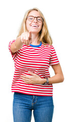 Beautiful young woman wearing glasses over isolated background Laughing of you, pointing to the camera with finger hand over chest, shame expression