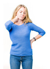 Fototapeta premium Beautiful young woman wearing blue sweater over isolated background Suffering of neck ache injury, touching neck with hand, muscular pain