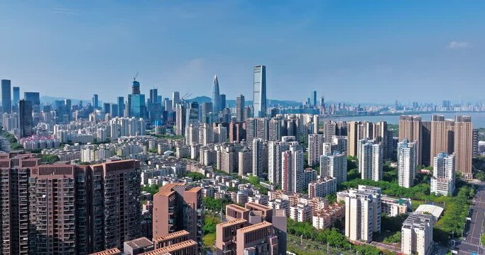 Aerial forward shot of Shenzhen Financial District skyline and coastline