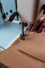 Máquina de costura, papel pardo e linha roxa