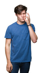 Young handsome man wearing blue t-shirt over isolated background mouth and lips shut as zip with...