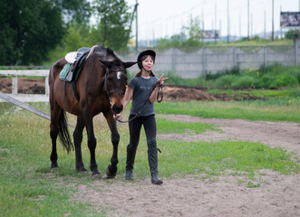 Teenage girl leading a horse