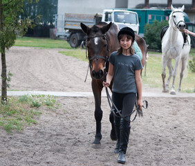 Teenage girl leading a horse