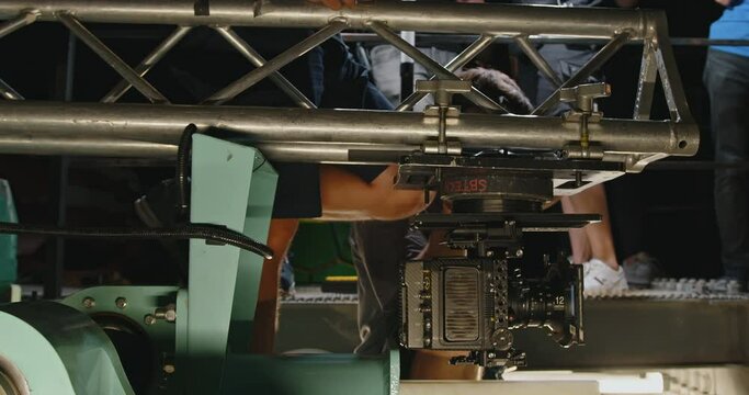 A movie camera mounted on a roller coaster cart.