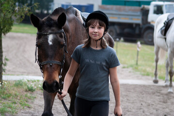 Teenage girl leading a horse