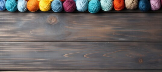 Rainbow wool yarn balls on gray background   copy space for text design or advertising concept.