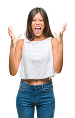 Young asian woman over isolated background crazy and mad shouting and yelling with aggressive expression and arms raised. Frustration concept.