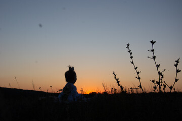 silhouette of a person watching the sunset