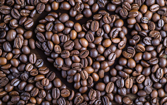 Closeup image of coffee beans arranged in heart shaped.