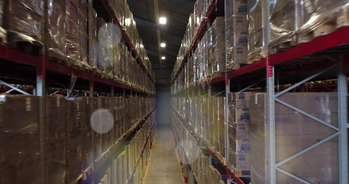 View of the inside of a warehouse with shelves full of goods.