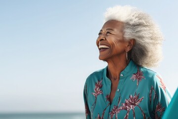 Side view, a happy 79-year-old black woman, with surfboard, at beach, teal clothes , in a commercial photography style