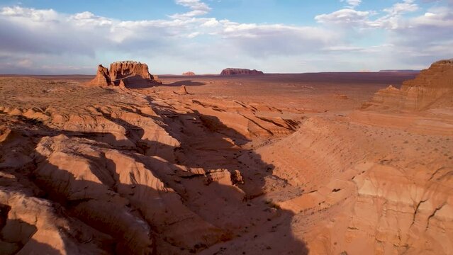 Drone flying towards Monument valley rock formations in Utah, USA. Aerial view of famous landmark in western USA. Cinematic drone footage.