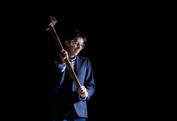 Builder boy child with a sledgehammer, isolated on a black background