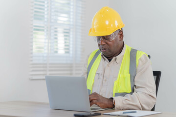  industrial engineers sitting and thoughtful in the office using digital tablet computers for the construction.