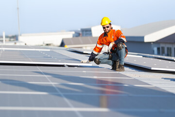 Professional electric engineers survey and inspect solar panels installation on the factory metal...