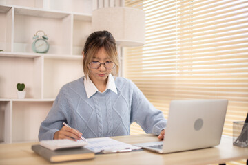 Woman analyzes data graphs, Works intently in his personal office, Employees working in the office, Businesswoman working in front of laptop.