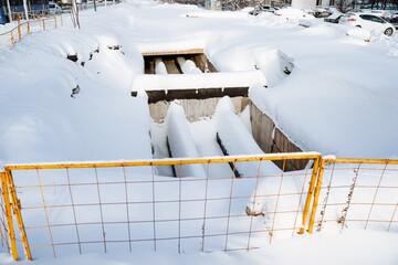 Repair of the pipeline in winter, ditch with hot heating pipes, emergency situation in the city,...