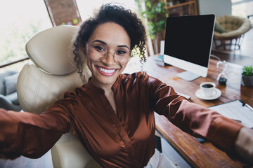Photo of gorgeous lawyer lady toothy smile sit chair take selfie showing empty space monitor...