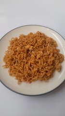 fried noodle (mie goreng) food on plate on white background. background concept of healthy food, food recipe, dish, meal, cuisine, breakfast, culinary, lunch, lifestyle, gourmet,eat,cook,carbohydrates