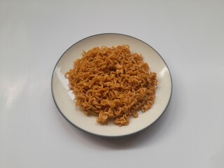 fried noodle (mie goreng) food on plate on white background. background concept of healthy food, food recipe, dish, meal, cuisine, breakfast, culinary, lunch, lifestyle, gourmet,eat,cook,carbohydrates